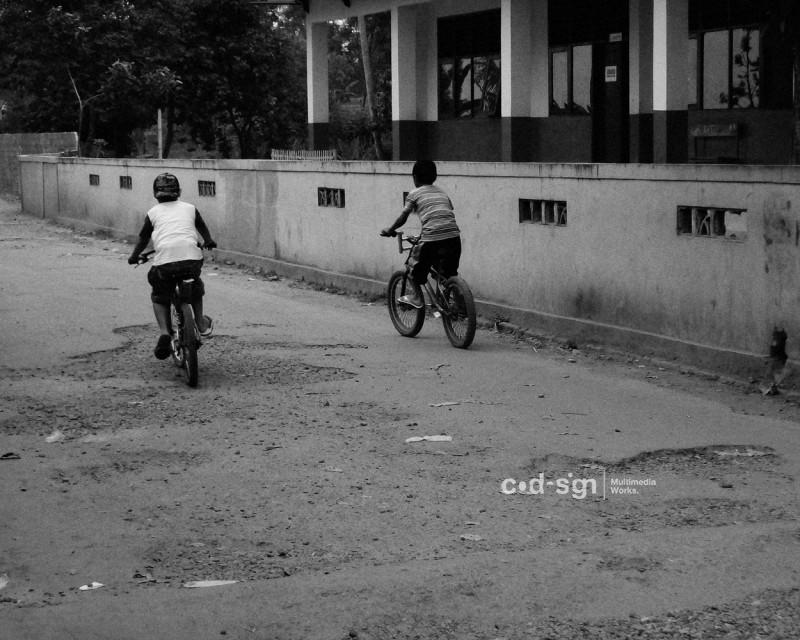 dua anak bersepeda di depan sekolah dasar, 2007